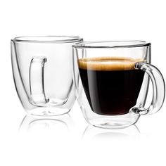 two glass mugs filled with liquid sitting next to each other on a white surface