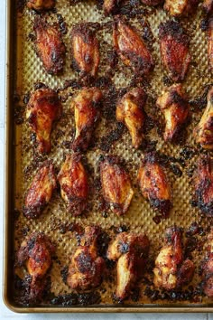 chicken wings on a baking sheet ready to be cooked in the oven for roasting