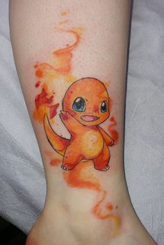 a small tattoo on the leg of a person with an orange and red fireball