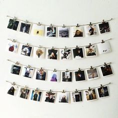 several polaroid photos hanging on a clothesline with pins attached to them and some magnets in the middle