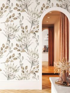 the wallpaper is decorated with leaves and branches, along with a vase full of flowers