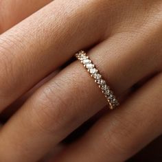 a woman's hand with a diamond ring on it