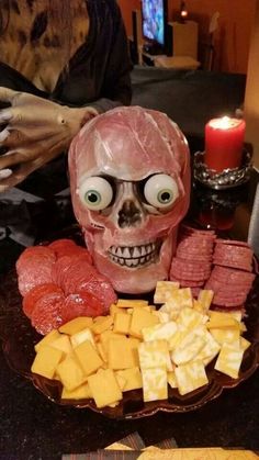 a table topped with lots of food and a skull