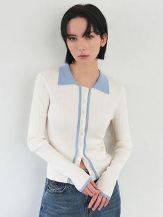 This product is an elegant collar button-up ribbed cardigan that blends classic charm with contemporary design elements. The crisp collar adds a preppy touch, while the vertical ribbing elongates the silhouette, making it a versatile piece for any wardrobe. The button-up front allows for easy layering, and the fitted shape ensures a sleek, polished look. - The cardigan is detailed with a ribbed texture, enhancing the fit and adding visual interest.- A handmade Cali medal decoration has been attached to the lower right side of the front panel to add a unique point of interest.- Its contrasting collar and placket provide a modern twist on the traditional cardigan style.- The snug fit and button-up front make it a stylish choice for both casual and more dressed-up occasions. Cardigan Style, Ribbed Cardigan, Ribbed Texture, Cardigan Fashion, Polished Look, Knitting Designs, Full Sleeve, Right Side, Snug Fit