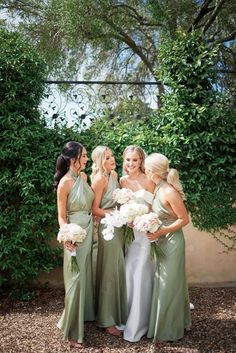 the bride and her bridesmaids are all dressed in green