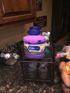 two containers are stacked on top of each other in front of a counter with food