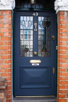 a blue front door with stained glass panels