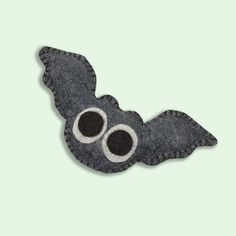 a felt bat with two eyes on it