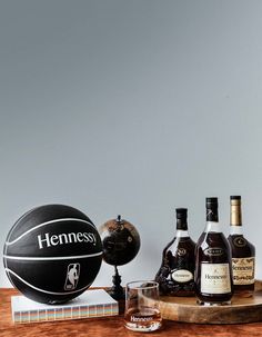 a wooden table topped with bottles of liquor and a basketball