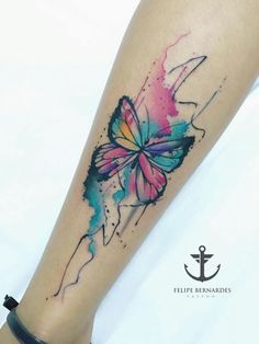 a colorful butterfly tattoo on the leg