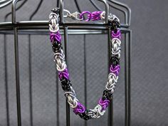 Celebrate asexual pride with this vibrant Byzantine pattern chainmail bracelet! The rings are aluminum, so they are lightweight, won't tarnish, and won't rust. The clasp is a nickel-free steel alloy, and the total length is 8.5 inches (21.5 cm). Brought to you by Misfits Collective member Lady Bedlam Creations. Asexual Ring, Byzantine Pattern, Chainmail Patterns, Chainmail Bracelet, Pride Bracelet, Asexual Pride, Chain Mail, Chain Link Bracelet, Chain Styles