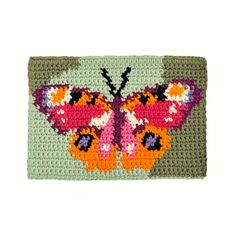 a close up of a crocheted butterfly on a white background