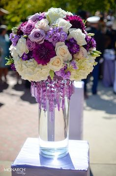 a vase filled with purple and white flowers