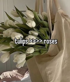 there is a bag with flowers in it and the words tulips = > > > roses