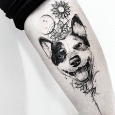 a black and white photo of a dog with flowers on it's leg