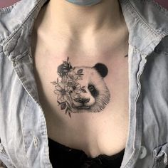 a woman's chest with a panda and flowers tattoo on it