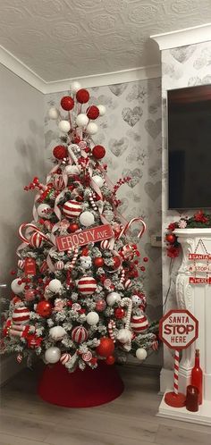 a christmas tree decorated with candy canes and ornaments in red, white and silver