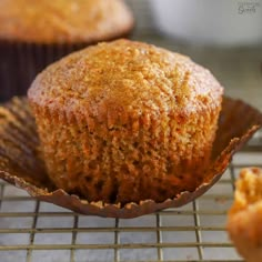 a muffin sitting on top of a cooling rack next to other muffins