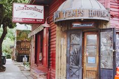 an old red building with two doors and a sign on the side of it that says pitt's house