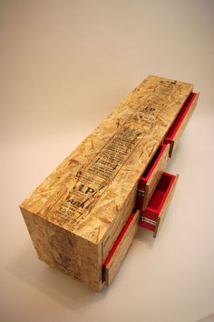 a wooden table with two red drawers on it