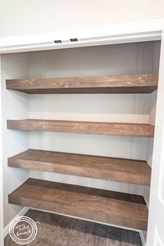 an empty closet with shelving and carpeting on the floor in front of it