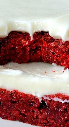 two pieces of red velvet cake with white frosting