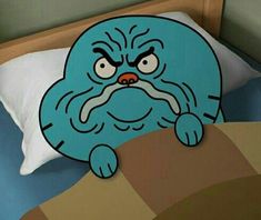 a bed with an angry cartoon character on it's head and pillow in the foreground