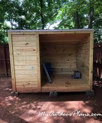 a wooden outhouse with the door open