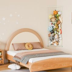 a bedroom with a bed and toys on the wall