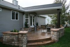 a patio with stone steps and seating area