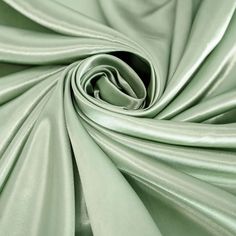 a close up view of a green satin fabric