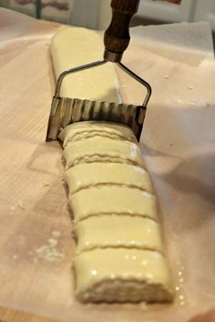 a piece of food is being prepared on a cutting board