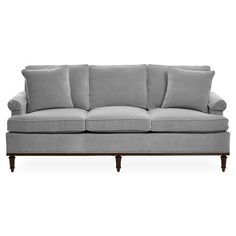 a gray couch sitting on top of a white floor