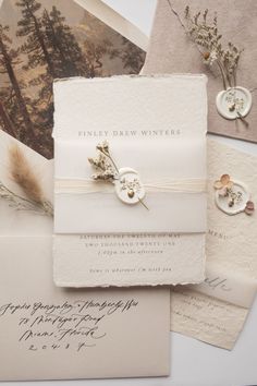 the wedding stationery is laid out on top of each other