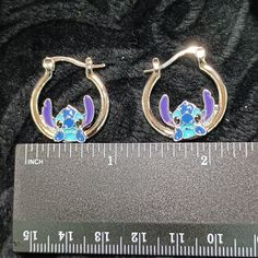 Disney Authorized Stitch Design Dangle Hoop Earrings No Markings Or Stamps Visible. .78" In X . 98" In *Please See Photos For Additional Details As To View The New Unused Condition Of The Item *** Perfect For Gifting Comes With A Sheer Drawstring Bag For Gifting Or Storage (Color & Design Varies) Dangle Hoop Earrings, Disney Jewelry, Stitch Design, Cute Jewelry, Blue And Silver, Drawstring Bag, Color Design, Jewelry Earrings, Hoop Earrings