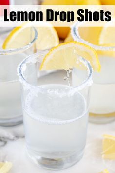 lemon drop shots in glasses with ice and sliced lemons