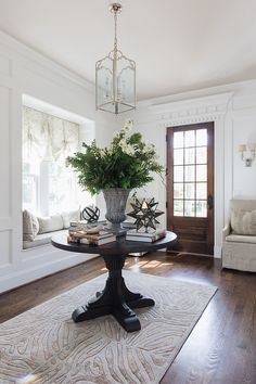 a table with a vase on it in the middle of a room