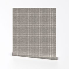 a gray and white checkered wallpaper on a white background, with the fabric folded over it