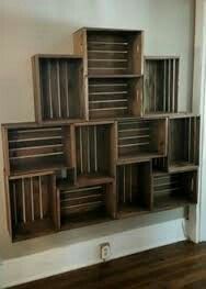 several wooden crates stacked on top of each other in a room with hard wood floors