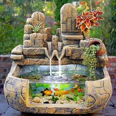 a fish tank filled with lots of water next to a brick wall and planter