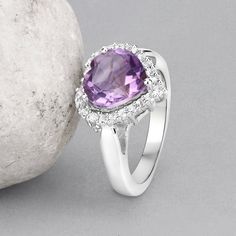 "Amethyst Ring, Halo Amethyst Heart Silver Ring, Natural Amethyst Ring for Women, February Birthstone Ring Flaunt yourself with this amethyst & white topaz halo ring. The natural gemstones have a combined weight of 3.53 carats and are set in .925 sterling silver with rhodium plating. The purple hue of this ring adds a pop of color to any look! The understated design and vibrant stones make this ring perfect for every occasion. amethyst halo silver ring, amethyst ring, amethyst silver ring, n Heart Cut Amethyst Ring With Accent Stones, Purple Gemstone Heart Ring For Promise, Amethyst Gemstone Heart Ring For Wedding, Purple Gemstone Heart Promise Ring, Amethyst Diamond Ring With Gemstone Accents As Gift, Heart-shaped Purple Amethyst Ring For Wedding, Amethyst Promise Ring With Cubic Zirconia Accents, Purple Heart Amethyst Ring With Accent Stones, Heart Cut Amethyst Jewelry With Center Stone