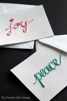 three greeting cards with the word happy written in cursive writing on them and some candy canes