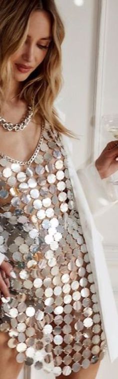 a woman wearing a silver sequin top