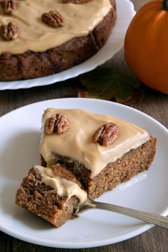 there is a piece of cake on the plate and another slice has pecans in it