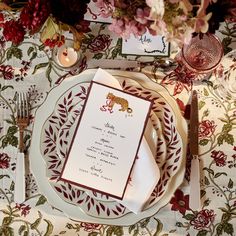 the table is set with red and white place settings