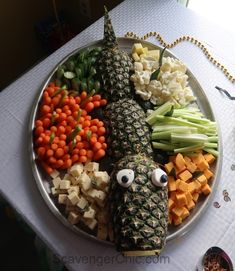 a plate filled with different types of food on top of a white tablecloth covered table