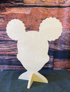 a wooden cutout of a mickey mouse head