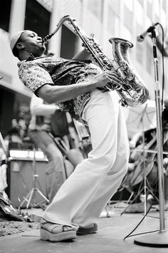 a man is playing the saxophone on stage