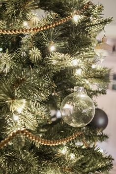 a close up of a christmas tree with ornaments on it