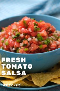 fresh tomato salsa in a blue bowl with tortilla chips on the side and text overlay